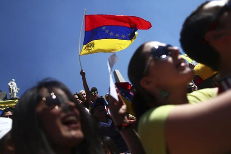 A Venezuelan opposition supporter waves a Venezuelan flag during a protest against Venezuelan President Nicolas Maduro's government at Angel A Venezuelan opposition supporter waves a Venezuelan flag during a protest against Venezuelan President Nicolas Maduro's government at Angel