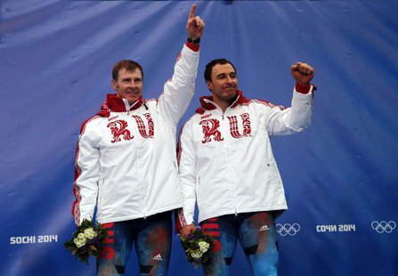 Russia's pilot Alexander Zubkov (L) and Alexey Voevoda celebrate on the podium at the flower ceremony after winning the men's two-man bobsle Russia's pilot Alexander Zubkov (L) and Alexey Voevoda celebrate on the podium at the flower ceremony after winning the men's two-man bobsle