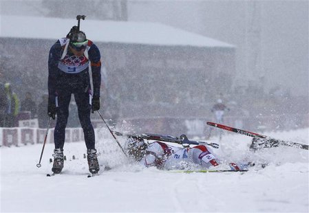 Norway's Emil Hegle Svendsen celebrates as France's Martin Fourcade (R) lunges and falls, as they cross the finish line during the men's bia Norway's Emil Hegle Svendsen celebrates as France's Martin Fourcade (R) lunges and falls, as they cross the finish line during the men's bia
