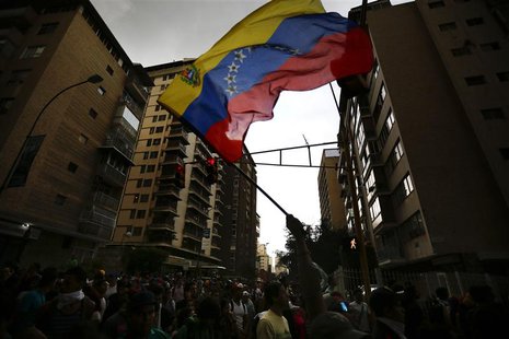 An opposition supporter waves a national flag during a protest against President Nicolas Maduro's government in Caracas February 17, 2014. R An opposition supporter waves a national flag during a protest against President Nicolas Maduro's government in Caracas February 17, 2014. R
