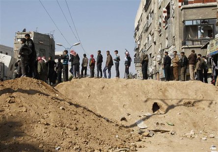 Syrian civilians are seen in Babila town, southeast Damascus February 17, 2014, after a local ceasefire agreement was reached. REUTERS/Khale Syrian civilians are seen in Babila town, southeast Damascus February 17, 2014, after a local ceasefire agreement was reached. REUTERS/Khale