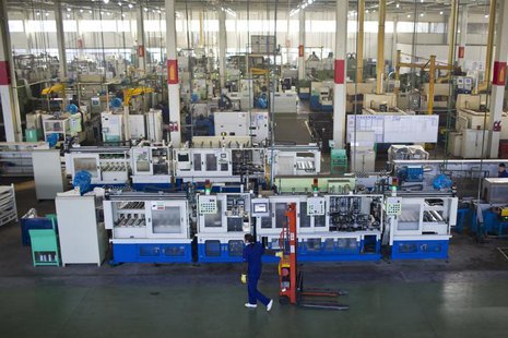 An employee works at a production line at a Wanxiang electric vehicle factory in Hangzhou, Zhejiang province, January 22, 2014. REUTERS/Aly An employee works at a production line at a Wanxiang electric vehicle factory in Hangzhou, Zhejiang province, January 22, 2014. REUTERS/Aly