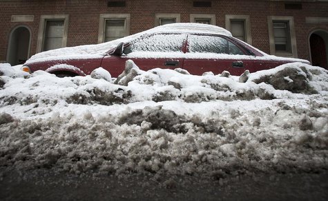 A car that is completely inundated by snow and ice that have accumulated from recent storms is pictured in the Manhattan borough of New York A car that is completely inundated by snow and ice that have accumulated from recent storms is pictured in the Manhattan borough of New York