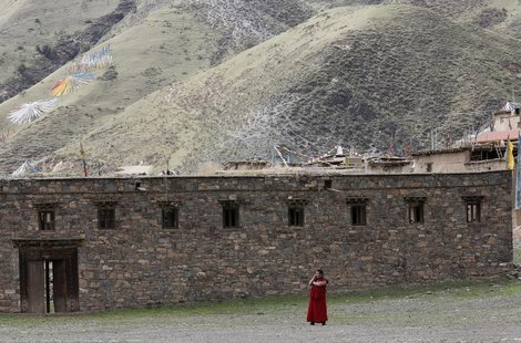 A Tibetan monk uses a mobile phone near the Dzamthang Jonang monastery in Barma township May 16, 2013. REUTERS/Kim Kyung-Hoon A Tibetan monk uses a mobile phone near the Dzamthang Jonang monastery in Barma township May 16, 2013. REUTERS/Kim Kyung-Hoon