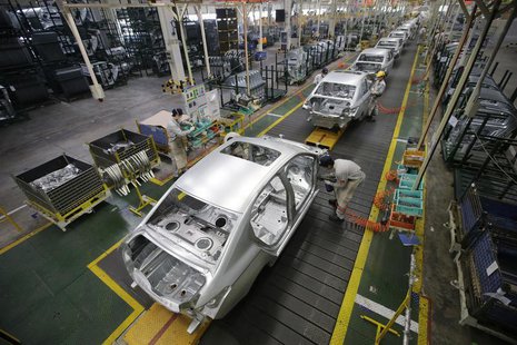 Employees assemble cars at a production line of Dongfeng Peugeot Citroen Automobile factory in Wuhan, Hubei province, February 13, 2014. REU Employees assemble cars at a production line of Dongfeng Peugeot Citroen Automobile factory in Wuhan, Hubei province, February 13, 2014. REU