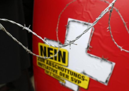 A poster against the 'mass immigration initiative' of the Swiss Socalist Party SPS is seen through barbed wire fence on the Federal Square b A poster against the 'mass immigration initiative' of the Swiss Socalist Party SPS is seen through barbed wire fence on the Federal Square b