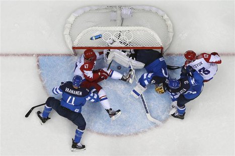 Russia's Alexander Radulov (47) tries to push the puck into the goal as Finland's goalie Tuukka Rask (3rd R) defends during the third period Russia's Alexander Radulov (47) tries to push the puck into the goal as Finland's goalie Tuukka Rask (3rd R) defends during the third period