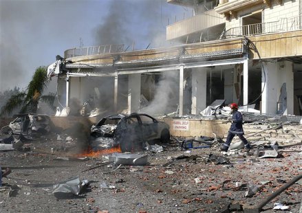 A civil defence member walks at the site of an explosion near the Iranian cultural center in the southern suburbs of Beirut February 19, 201 A civil defence member walks at the site of an explosion near the Iranian cultural center in the southern suburbs of Beirut February 19, 201