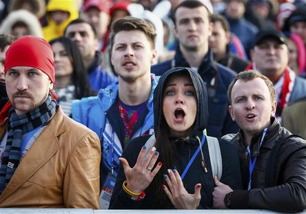 Russian fans react as they watch a broadcast of the ice hockey quarter-final match between Russia and Finland in the Olympic Park during the Russian fans react as they watch a broadcast of the ice hockey quarter-final match between Russia and Finland in the Olympic Park during the