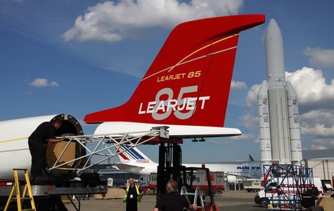 Workers install the tail section on a full-scale cabin mockup of the all-composite Bombardier Aerospace Learjet 85 business jet , four days Workers install the tail section on a full-scale cabin mockup of the all-composite Bombardier Aerospace Learjet 85 business jet , four days