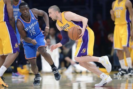 Feb 13, 2014; Los Angeles, CA, USA; Los Angeles Lakers guard Steve Blake (5) handles the ball defended by Oklahoma City Thunder guard Reggie Feb 13, 2014; Los Angeles, CA, USA; Los Angeles Lakers guard Steve Blake (5) handles the ball defended by Oklahoma City Thunder guard Reggie
