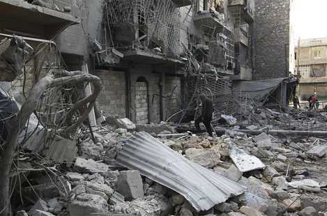 A man walks amid rubble of damaged buildings in the al-Myassar neighbourhood of Aleppo February 19, 2014. REUTERS/Jalal Al-Mamo A man walks amid rubble of damaged buildings in the al-Myassar neighbourhood of Aleppo February 19, 2014. REUTERS/Jalal Al-Mamo