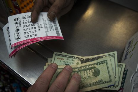 A man purchases New York State Lottery tickets for the $400 million Powerball lottery in New York's financial district February 19, 2014. RE A man purchases New York State Lottery tickets for the $400 million Powerball lottery in New York's financial district February 19, 2014. RE