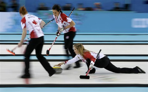 Canada's lead Dawn McEwen (L) and second Jill Officer prepare to sweep as skip Jennifer Jones (R) delivers a stone in their women's gold med Canada's lead Dawn McEwen (L) and second Jill Officer prepare to sweep as skip Jennifer Jones (R) delivers a stone in their women's gold med