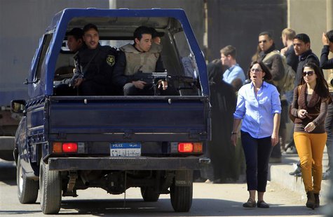 Foreign journalists and relatives of Al-Jazeera journalists walk near a police vehicle outside Cairo's Tora prison, where the trial of Al Ja Foreign journalists and relatives of Al-Jazeera journalists walk near a police vehicle outside Cairo's Tora prison, where the trial of Al Ja