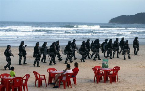Riot police patrol the Santinho beach next the Costao do Santinho hotel ahead of the 2014 FIFA World Cup in Florianopolis, Santa Catarina st Riot police patrol the Santinho beach next the Costao do Santinho hotel ahead of the 2014 FIFA World Cup in Florianopolis, Santa Catarina st