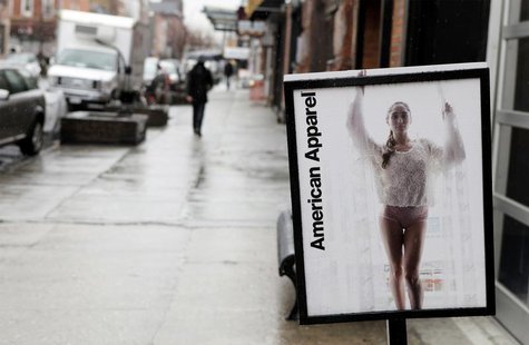 Pedestrians walk past an American Apparel sign outside one of their stores in New York April 1, 2011. REUTERS/Lucas Jackson Pedestrians walk past an American Apparel sign outside one of their stores in New York April 1, 2011. REUTERS/Lucas Jackson
