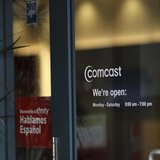 A Comcast sign is shown on the entrance to its store in San Francisco, California February 13, 2014. REUTERS/Robert Galbraith A Comcast sign is shown on the entrance to its store in San Francisco, California February 13, 2014. REUTERS/Robert Galbraith