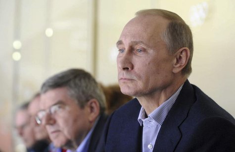 Russia's President Vladimir Putin (R) watches the men's preliminary round ice hockey game between Russia and the U.S. at the Sochi 2014 Wint Russia's President Vladimir Putin (R) watches the men's preliminary round ice hockey game between Russia and the U.S. at the Sochi 2014 Wint