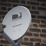 A Direct TV dish is seen outside a home in the Queens borough of New York July 29, 2013. REUTERS/Shannon Stapleton A Direct TV dish is seen outside a home in the Queens borough of New York July 29, 2013. REUTERS/Shannon Stapleton