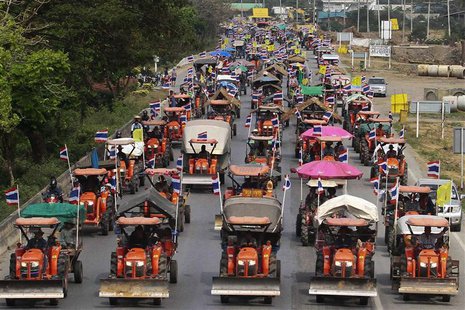 Farmers drive their tractors and other farming vehicles on a road in Ang Thong province, towards Bangkok, February 20, 2014. REUTERS/Stringe Farmers drive their tractors and other farming vehicles on a road in Ang Thong province, towards Bangkok, February 20, 2014. REUTERS/Stringe