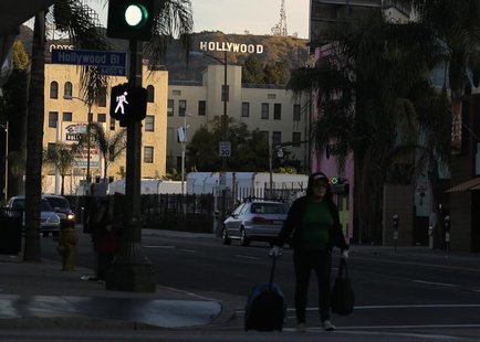 A women walks with her belongings under the Hollywood sign and across Hollywood Boulevard in Hollywood, California February 22, 2012. REUTER A women walks with her belongings under the Hollywood sign and across Hollywood Boulevard in Hollywood, California February 22, 2012. REUTER