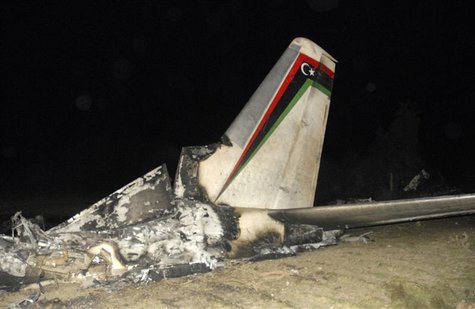 The wreckage of a Libyan military plane is seen in Grombalia town, south of Tunis, February 21, 2014. REUTERS/Stringer The wreckage of a Libyan military plane is seen in Grombalia town, south of Tunis, February 21, 2014. REUTERS/Stringer