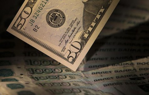 U.S. dollars and Russian roubles are seen in this illustration picture taken in Moscow February 17, 2014. REUTERS/Maxim Shemetov U.S. dollars and Russian roubles are seen in this illustration picture taken in Moscow February 17, 2014. REUTERS/Maxim Shemetov