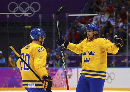 Sweden's Erik Karlsson (R) celebrates his goal against Finland with teammate Alexander Steen during the second period of the men's ice hocke Sweden's Erik Karlsson (R) celebrates his goal against Finland with teammate Alexander Steen during the second period of the men's ice hocke