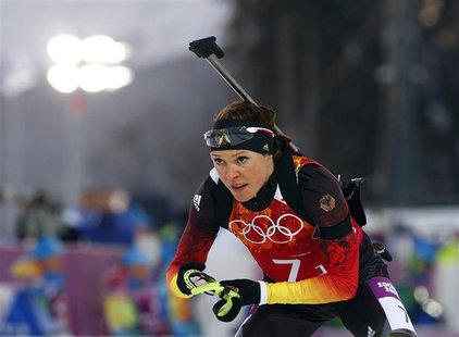 Germany's Evi Sachenbacher-Stehle leaves the shooting range during the mixed biathlon relay at the Sochi 2014 Winter Olympics, in this pictu Germany's Evi Sachenbacher-Stehle leaves the shooting range during the mixed biathlon relay at the Sochi 2014 Winter Olympics, in this pictu