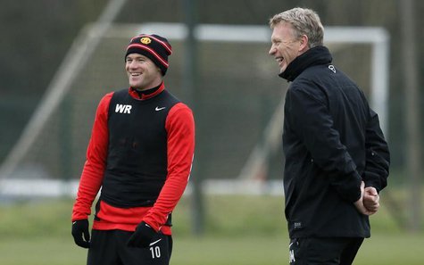 Manchester United's manager David Moyes (R) and player Wayne Rooney smile during a training session at the club's Carrington training comple Manchester United's manager David Moyes (R) and player Wayne Rooney smile during a training session at the club's Carrington training comple