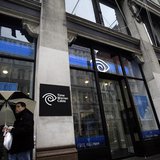 A man walks past the Time Warner Cable headquarters in New York February 13, 2014. REUTERS/Joshua Lott A man walks past the Time Warner Cable headquarters in New York February 13, 2014. REUTERS/Joshua Lott