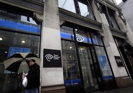 A man walks past the Time Warner Cable headquarters in New York February 13, 2014. REUTERS/Joshua Lott A man walks past the Time Warner Cable headquarters in New York February 13, 2014. REUTERS/Joshua Lott