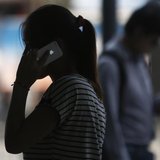 A woman speaks on her iPhone as she walks on a busy street in downtown Shanghai September 10, 2013. REUTERS/Aly Song A woman speaks on her iPhone as she walks on a busy street in downtown Shanghai September 10, 2013. REUTERS/Aly Song