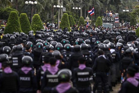 Thai riot police stand guard as anti-government protesters rally inside a compound of the Thai Royal Police Club in Bangkok February 21, 201 Thai riot police stand guard as anti-government protesters rally inside a compound of the Thai Royal Police Club in Bangkok February 21, 201