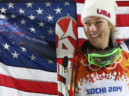 First-placed Mikaela Shiffrin of the U.S. poses with a U.S. flag during the flower ceremony for the women's alpine skiing slalom event at th First-placed Mikaela Shiffrin of the U.S. poses with a U.S. flag during the flower ceremony for the women's alpine skiing slalom event at th