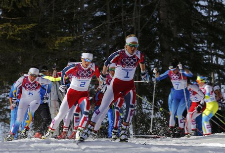 Norway's Therese Johaug (C) and Marit Bjoergen (centre L) ski ahead of the pack during the women's cross-country 30 km mass start free event Norway's Therese Johaug (C) and Marit Bjoergen (centre L) ski ahead of the pack during the women's cross-country 30 km mass start free event