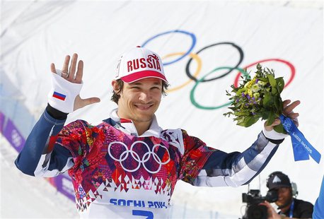 Russia's winner Vic Wild celebrates during flower ceremony after the men's parallel snowboard finals at the 2014 Sochi Winter Olympic Games Russia's winner Vic Wild celebrates during flower ceremony after the men's parallel snowboard finals at the 2014 Sochi Winter Olympic Games