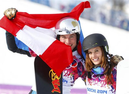 Austria's Julia Dujmovits (R), winner of the women's parallel slalom snowboard final, and her compatriot Benjamin Karl (L), who finished thi Austria's Julia Dujmovits (R), winner of the women's parallel slalom snowboard final, and her compatriot Benjamin Karl (L), who finished thi
