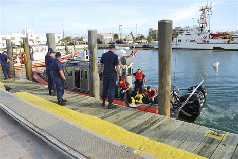 United States Coast Guard officers arrive at their base in Key West, Florida, with a Cuban man they rescued on one of the uninhabited island United States Coast Guard officers arrive at their base in Key West, Florida, with a Cuban man they rescued on one of the uninhabited island