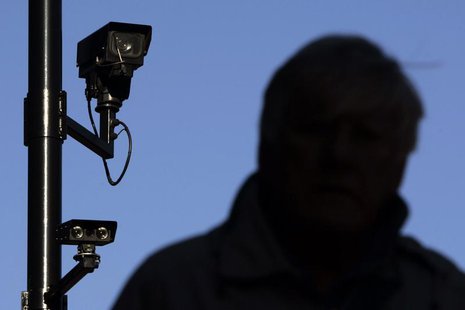 A security camera overlooks a man as he walks down a street in London November 2, 2006. REUTERS/Luke MacGregor A security camera overlooks a man as he walks down a street in London November 2, 2006. REUTERS/Luke MacGregor