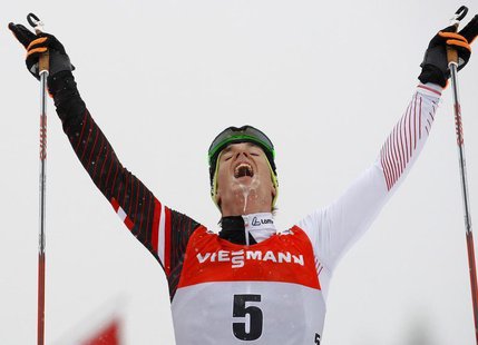 Johannes Duerr of Austria celebrates as he crosses the finish line to third place during the men's FIS World Cup cross-country skiing 9km fr Johannes Duerr of Austria celebrates as he crosses the finish line to third place during the men's FIS World Cup cross-country skiing 9km fr