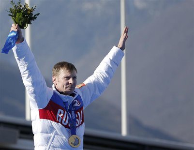 Russia's pilot Alexander Zubkov poses with a gold medal during a ceremony for the four-man bobsleigh event at the Sochi 2014 Winter Olympics Russia's pilot Alexander Zubkov poses with a gold medal during a ceremony for the four-man bobsleigh event at the Sochi 2014 Winter Olympics