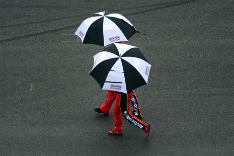 Feb 23, 2014; Daytona Beach, FL, USA; NASCAR Sprint Cup Series driver Jamie McMurray (1) walks under an umbrella during a rain delay during Feb 23, 2014; Daytona Beach, FL, USA; NASCAR Sprint Cup Series driver Jamie McMurray (1) walks under an umbrella during a rain delay during