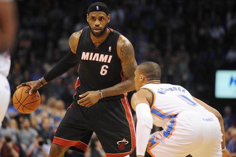 Feb 20, 2014; Oklahoma City, OK, USA; Miami Heat small forward LeBron James (6) handles the ball against Oklahoma City Thunder point guard R Feb 20, 2014; Oklahoma City, OK, USA; Miami Heat small forward LeBron James (6) handles the ball against Oklahoma City Thunder point guard R