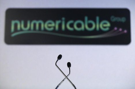A logo of French cable operator Numericable is seen behind microphones during a news conference in Paris, October 28, 2013. REUTERS/Christia A logo of French cable operator Numericable is seen behind microphones during a news conference in Paris, October 28, 2013. REUTERS/Christia