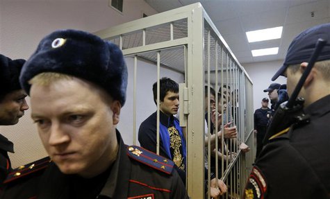Defendants in the "Bolotnaya" case stand in a holding cell as they wait for their sentencing during a court hearing in Moscow February 24, 2 Defendants in the "Bolotnaya" case stand in a holding cell as they wait for their sentencing during a court hearing in Moscow February 24, 2