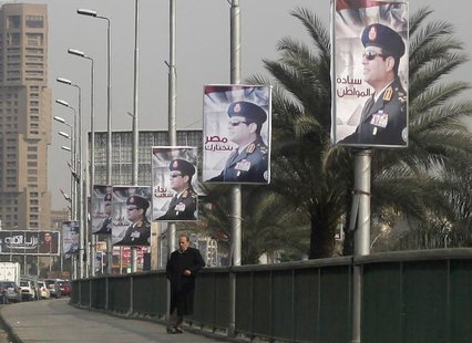 A man stands on a bridge where huge posters of Egypt's Army chief Field Marshal Abdel Fattah al-Sisi are hanged in central Cairo February 3, A man stands on a bridge where huge posters of Egypt's Army chief Field Marshal Abdel Fattah al-Sisi are hanged in central Cairo February 3,