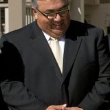 California Senator Ron Calderon watches Governor Arnold Schwarzenegger (not pictured) as he signs into law a bill that would move the date o California Senator Ron Calderon watches Governor Arnold Schwarzenegger (not pictured) as he signs into law a bill that would move the date o