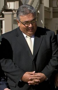 California Senator Ron Calderon watches Governor Arnold Schwarzenegger (not pictured) as he signs into law a bill that would move the date o California Senator Ron Calderon watches Governor Arnold Schwarzenegger (not pictured) as he signs into law a bill that would move the date o